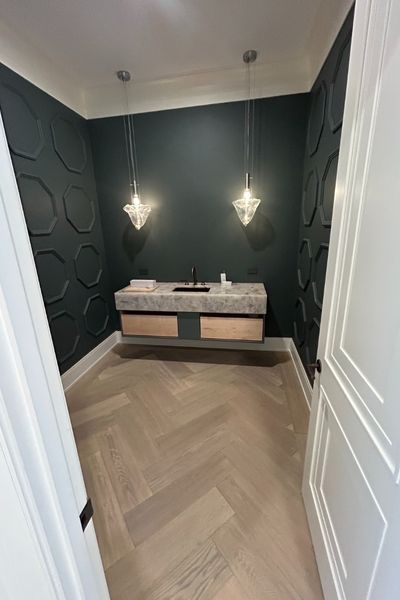 Franklin MA bathroom remodel installation with wood floors and dark accent wall